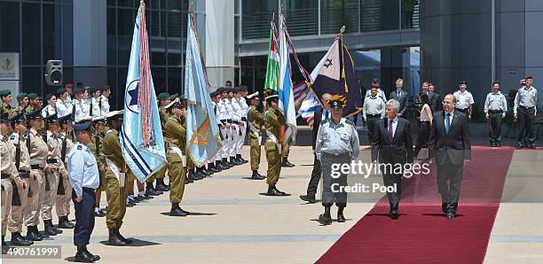 Israeli Defense Minister Moshe Ya'alon escorts US Defense Secretary Chuck Hagel past the honor guard upon the latter's arrival at The Kirya, the...