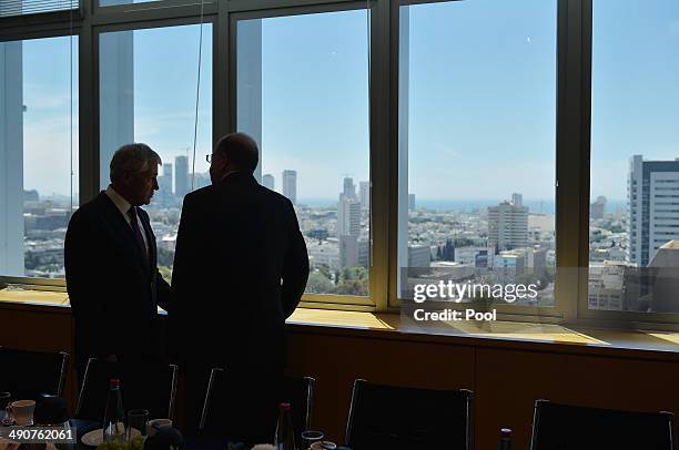 Israeli Defense Minister Moshe Ya'alon chats with US Defense Secretary Chuck Hagel before their bilateral meeting at The Kirya, the Israeli Defense...