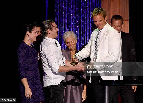 Director Shaun Monson accepts the River Phoenix Award from actor Joaquin Phoenix, Liberty Phoenix, Arlyn Phoenix and Jeffrey Weisberg onstage at...
