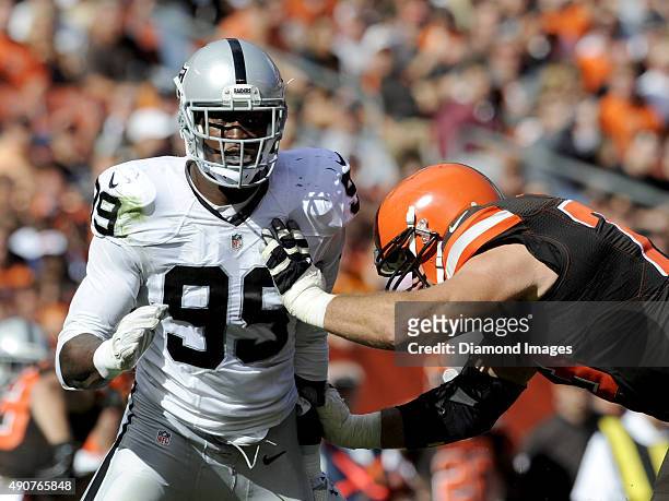 Linebacker Aldon Smith of the Oakland Raiders rushes around the block of left tackle Joe Thomas of the Cleveland Browns during a game on September...