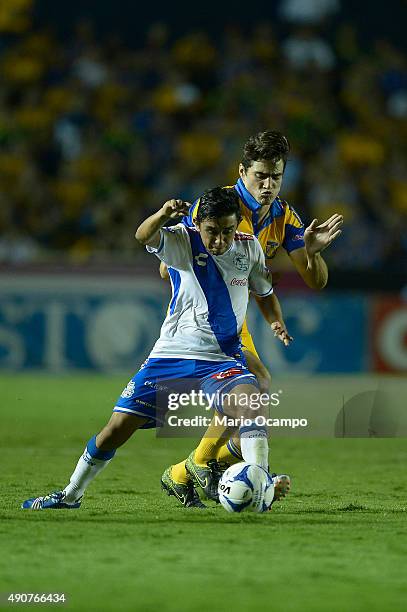 Antonio Briseño of Tigres fights for the ball with Christian Bermudez of Puebla during the 11th round match between Tigres UANL and Puebla as part of...
