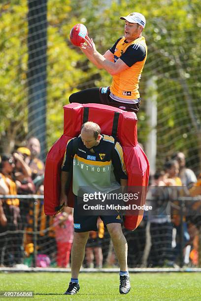 Jarryd Roughead of the Hawks marks the ball over assistant coach David Neitz during a Hawthorn Hawks AFL training session at Waverley Park on October...