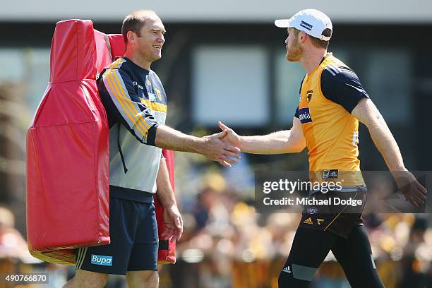 Jarryd Roughead of the Hawks and David Neitz slap hands during a Hawthorn Hawks AFL training session at Waverley Park on October 1, 2015 in...