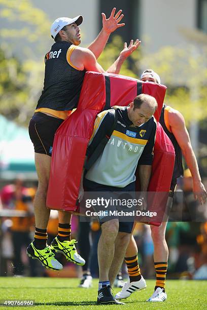 Brian Lake of the Hawks marks the ball over assistant coach David Neitz during a Hawthorn Hawks AFL training session at Waverley Park on October 1,...