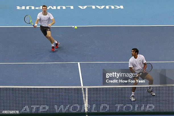 Rameez Junaid of Australia and Jonathan Marray of Germany competes against Raven Klaasen of RSA and Rajeev Ram of USA during the 2015 ATP Malaysian...