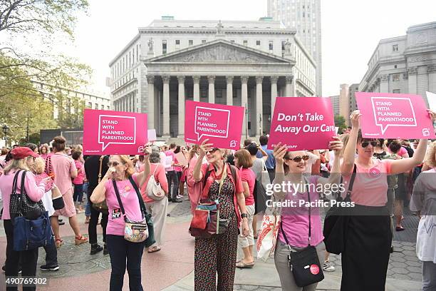 Planned Parenthood activists in pink hold signs in front the US courthouse. Activists and directors of Planned Parenthood, NYC, gathered in Foley...