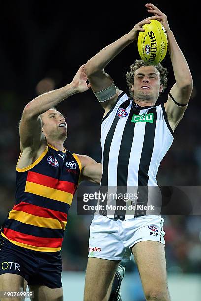 Jarrod Witts of the Magpies takes a mark infront of Ben Rutten of the Crows during the round nine AFL match between the Adelaide Crows and the...