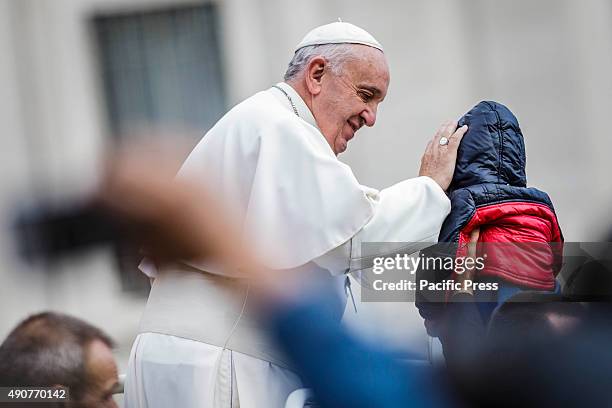 Pope Francis greets a baby as he attends Weekly General Audience in St. Peter's Square in Vatican City. Pope Francis recalled his Apostolic Journey...