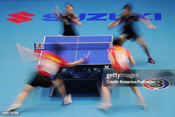 Oshima Yuya and Wakamiya Misako of Japan compete against Fan Zhendong and Chen Meng of China during Mixed doubles semi-final match of the 22nd 2015...