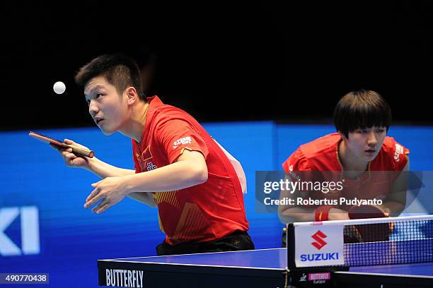 Fan Zhendong and Chen Meng of China compete against Oshima Yuya and Wakamiya Misako of Japan during Mixed doubles semi-final match of the 22nd 2015...