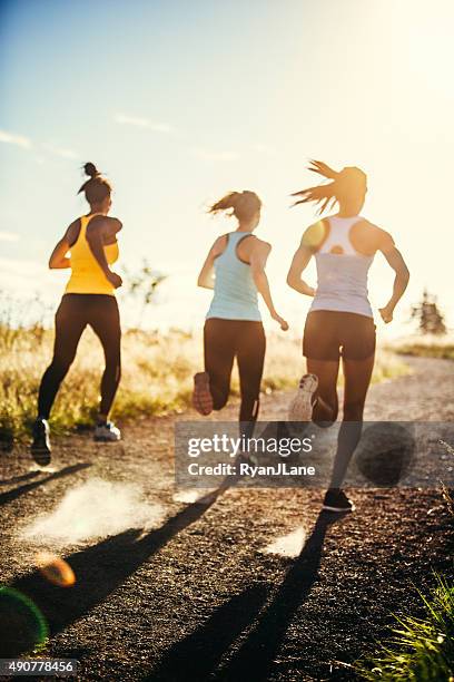 group of women running outdoors - group of people running stock pictures, royalty-free photos & images