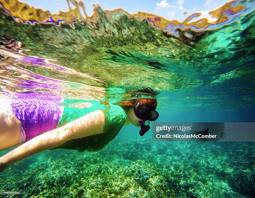 Young woman snorkling in Bali coral reef