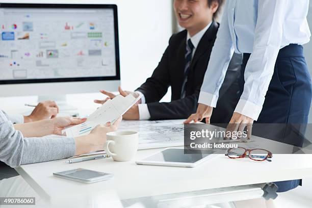 men and women to see the statistics chart in office - japan training session stock pictures, royalty-free photos & images