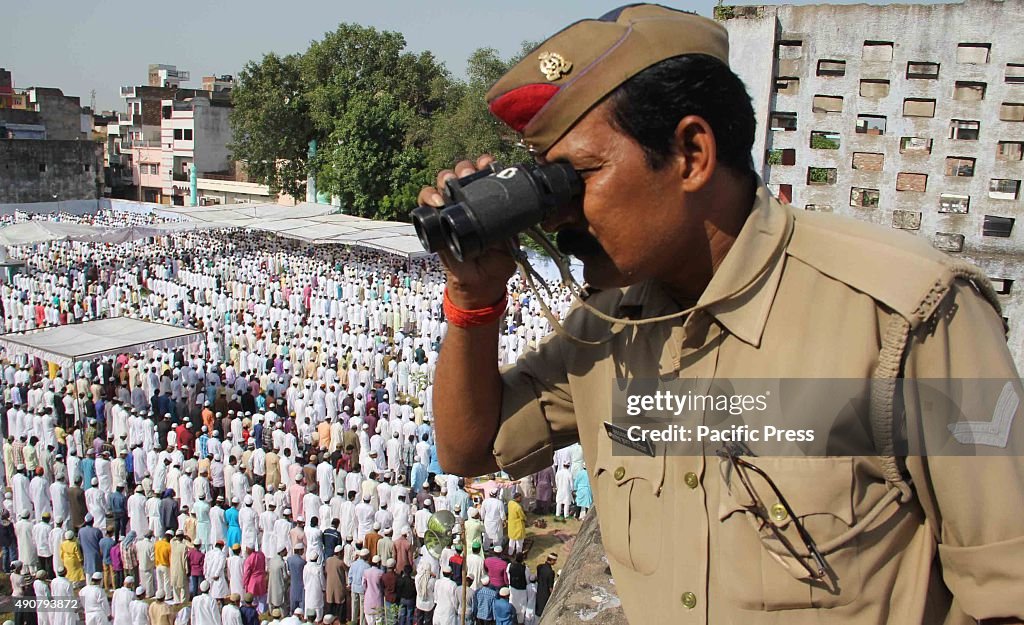 Policeman keeps an eye out for the devotees offering...