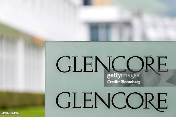 The Glencore company sign sits in the foreground against the backdrop of the Glencore Plc headquarters in Baar, Switzerland, on Wednesday, Sept. 30,...