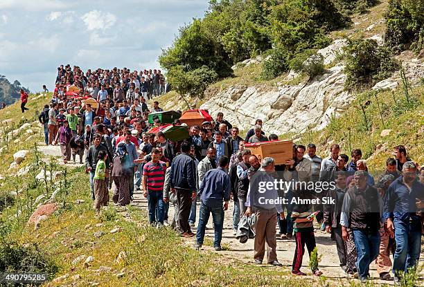 People carry the coffins of the miners to the cemetery after a mining disaster on May 15, 2014 in Soma, a district in Turkey's western province of...