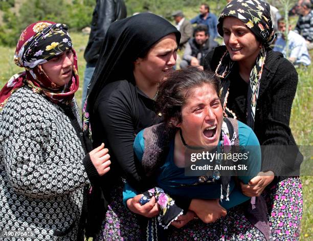 Relatives mourn during the funeral of the miners after a mining disaster on May 15, 2014 in Soma, a district in Turkey's western province of Manisa....