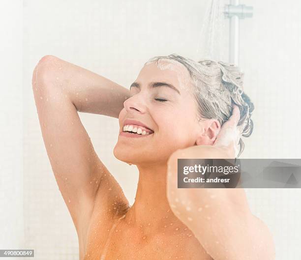 woman washing her hair - women washing hair stock pictures, royalty-free photos & images