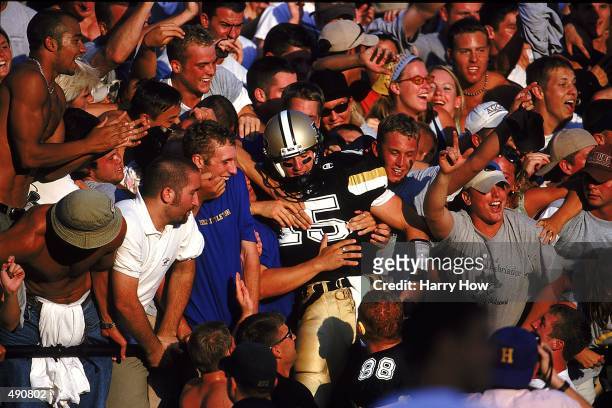 Drew Brees of the Purdue Boilermakers lands in the crowd during the game against the Notre Dame Fighting Irish at the Ross-Ade Stadium in West...