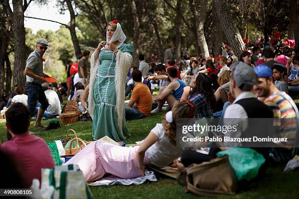 Woman dressed as 'Chulapa' tie her handkerchief during the San Isidro festivities at Pradera de San Isidro park on May 15, 2014 in Madrid, Spain....