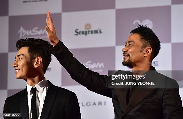 Hong Kong actor Simon Yam , also known as Yam Tat-Wah, and actor Han Ji-Seok pose on the red carpet for the opening ceremony of the Busan...