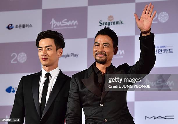 Hong Kong actor Simon Yam , also known as Yam Tat-Wah, and actor Han Ji-Seok pose on the red carpet for the opening ceremony of the Busan...