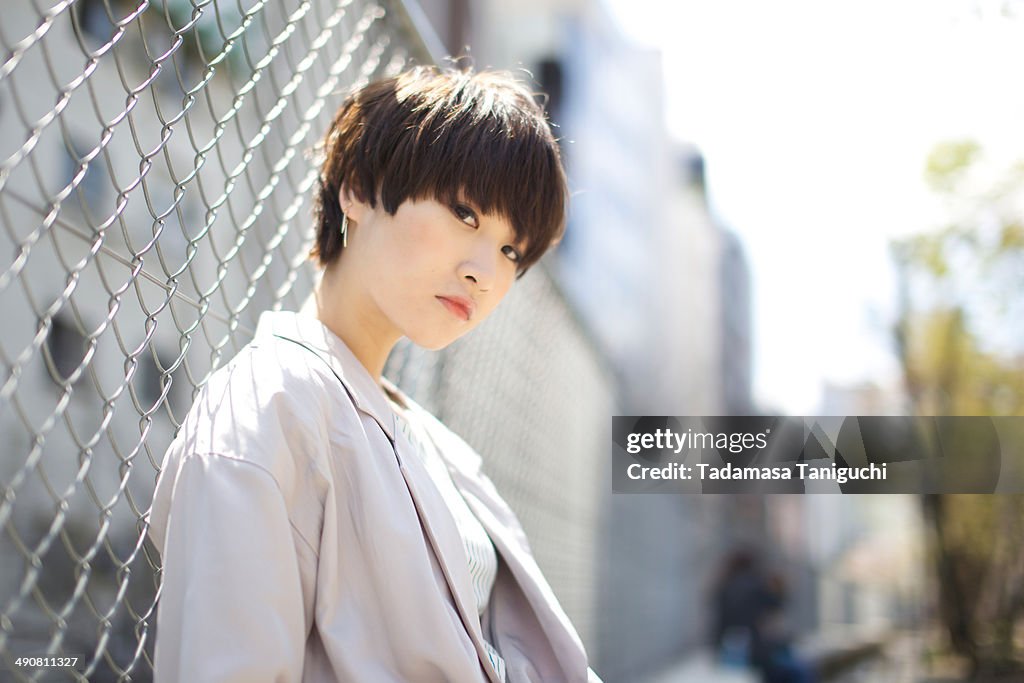 Woman in front of the fence