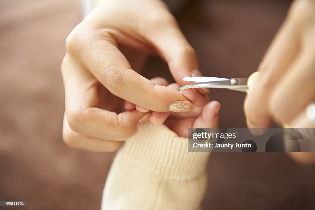 Mother cutting her baby's nail