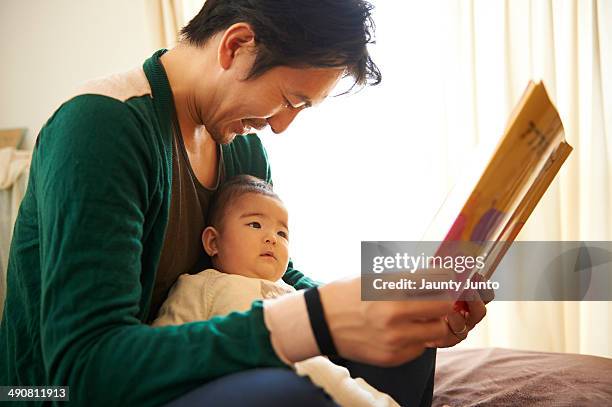 Father reading a picture book for his baby