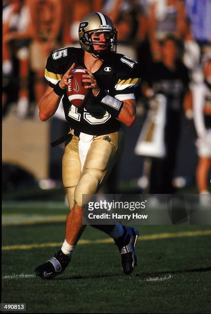 Quarterback Drew Brees of the Purdue Boilermakers moves to pass the ball during the game against the Notre Dame Fighting Irish at the Ross-Ade...