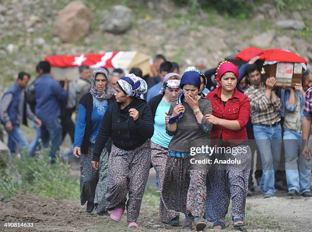 Relatives and family members of the miners killed in the coal mine fire in Soma, mourn during a funeral ceremony in Kinik district of Manisa, Turkey...