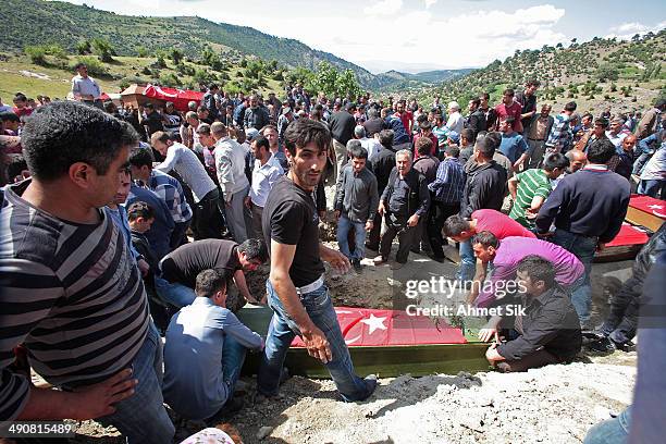 People attend the funeral of a miner who died in a fire at a coal mine at a cemetary on May 15, 2014 in Soma, a district in Turkey's western province...