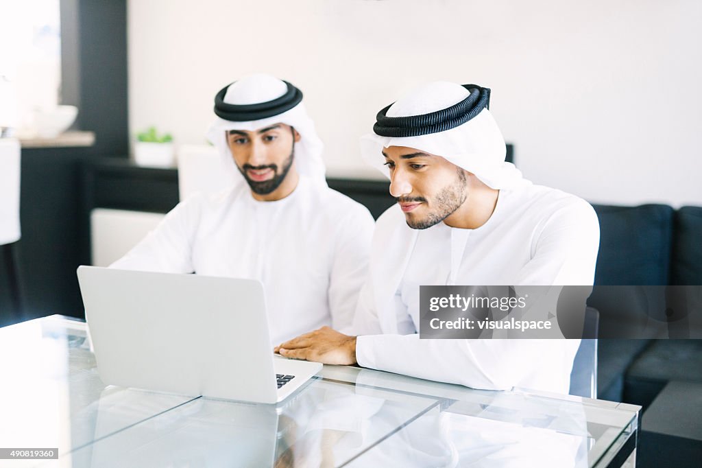 Two Arab Friends Watching Videos on Laptop