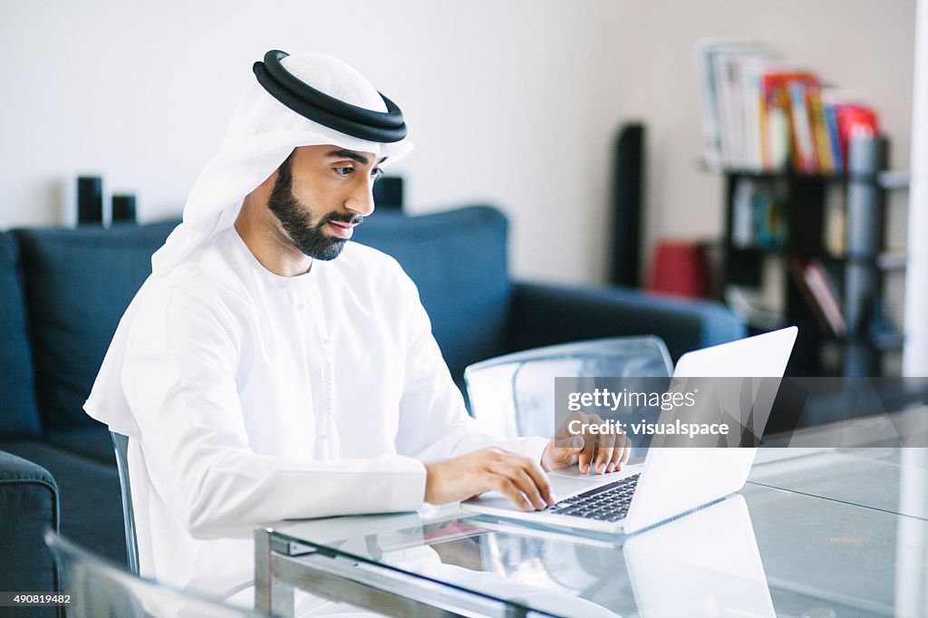 Content Arab Man Using Laptop at Home