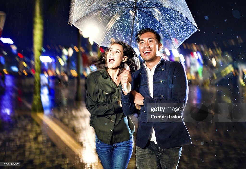 Multi-ethnic couple in Hong Kong under the rain