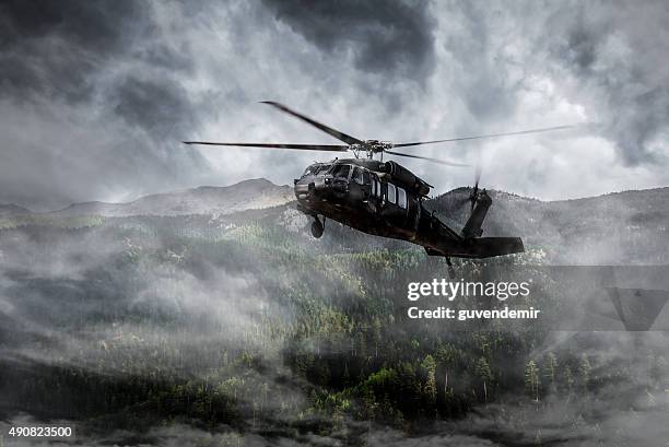 helicóptero militar moscas sobre montanhas com nevoeiroweather forecast - helicóptero militar imagens e fotografias de stock