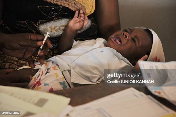 The BCG vaccine against tuberculosis provided by UNICEF is administered to a baby at the Noki health centre on September 10, 2015. AFP PHOTO/JUNIOR...