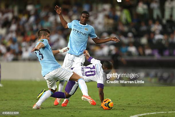 Ismail Matar of Al Ain is tackled by Dedryck Boyata of Manchester City during the friendly match between Al Ain and Manchester City at Hazza bin...
