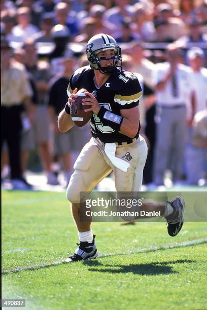 Quarterback Drew Brees of the Purdue Boilermakers moves back to pass the ball during the game against the Notre Dame Fighting Irish at the Ross-Ade...