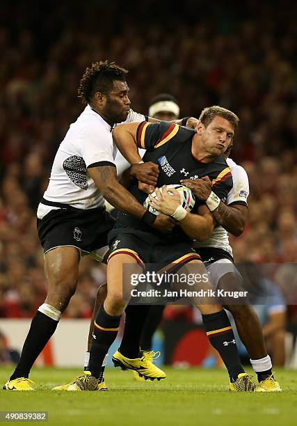 Dan Biggar of Wales is tackled by Metuisela Talebula of Fiji during the 2015 Rugby World Cup Pool A match between Wales and Fiji at Millennium...