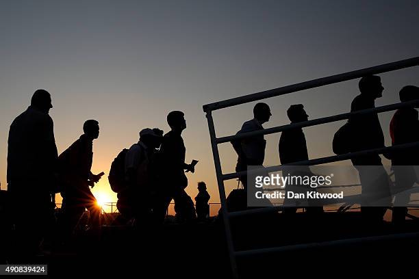Migrants board a ferry from the island of Kos for transport to the Greek mainland port of Piraeus on August 28, 2015 in Kos, Greece. From Piraeus...