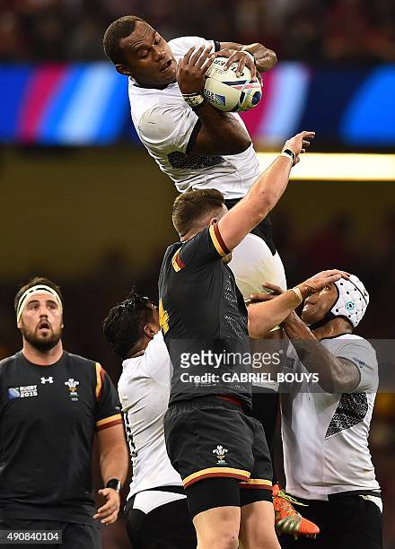 Fiji's lock Leone Nakarawa catches the ball in a line out against Wales' wing Alex Cuthbert during a Pool A match of the 2015 Rugby World Cup between...
