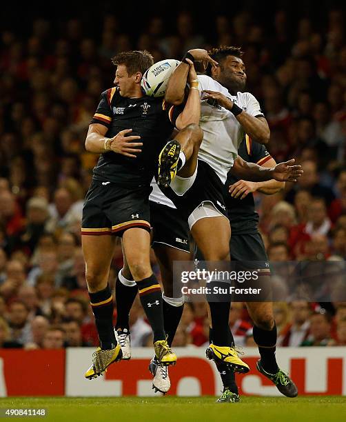Wales player Dan Biggar and Fiji fullback Metuisela Talebula compete for a high ball during the 2015 Rugby World Cup Pool A match between Wales and...