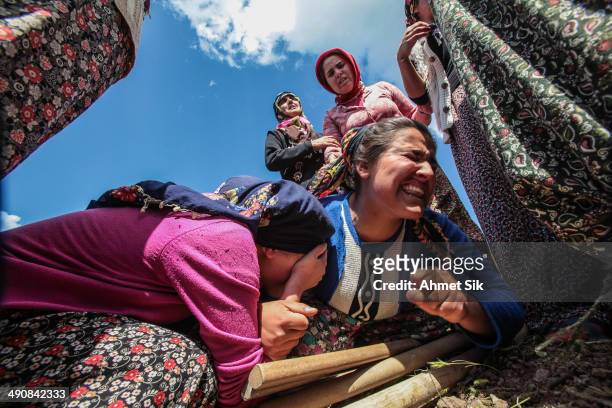 Relatives mourn during the funeral for the victims of a mining disaster on May 15, 2014 in Soma, a district in Turkey's western province of Manisa....