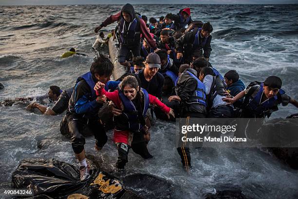 Refugees arrive on the shores of the Greek island of Lesbos after crossing the Aegean sea from Turkey on an inflatable boat on October 1, 2015 near...