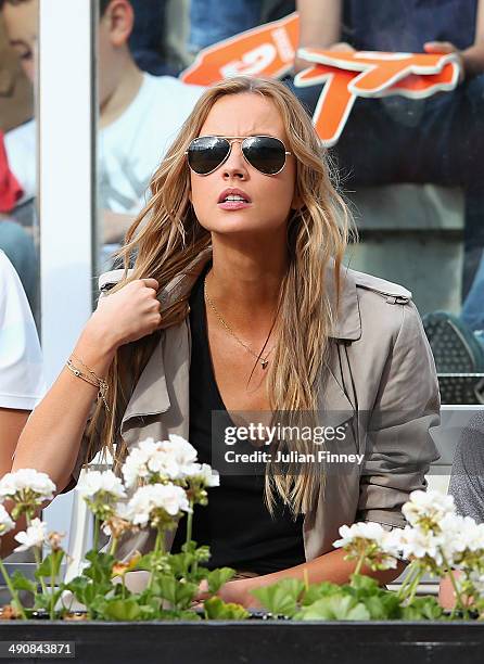 Ester Satorova watches Tomas Berdych of Czech Republic in action in his match against Grigor Dimitrov of Bulgaria during day five of the...