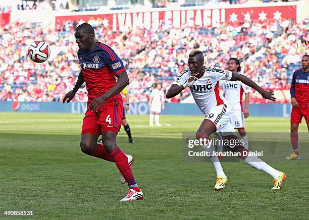 Bakary Soumare of the Chicago Fire controls the ball in front of Saer Sene of the New England Revolution during an MLS match at Toyota Park on...