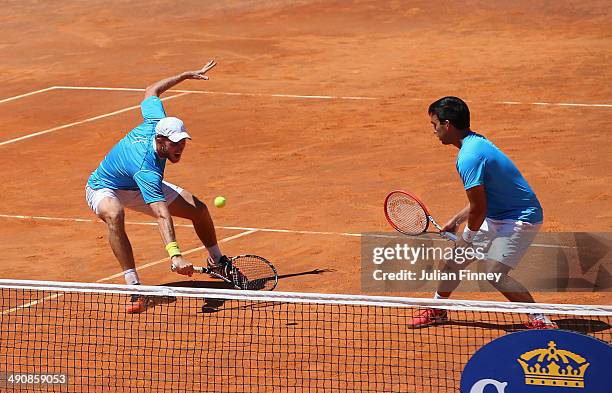 Treat Huey of Philiphines and Dominic Inglot of Great Britain in action in their doubles match against Robin Haase of Holland and Feliciano Lopez of...