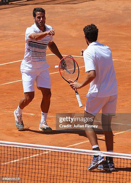 Feliciano Lopez of Spain and Robin Haase of Holland celebrate winning a game in the doubles against Treat Huey of Philiphines and Dominic Inglot of...