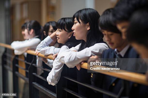 japanese kids relax on a bannister at school - samlingssal bildbanksfoton och bilder
